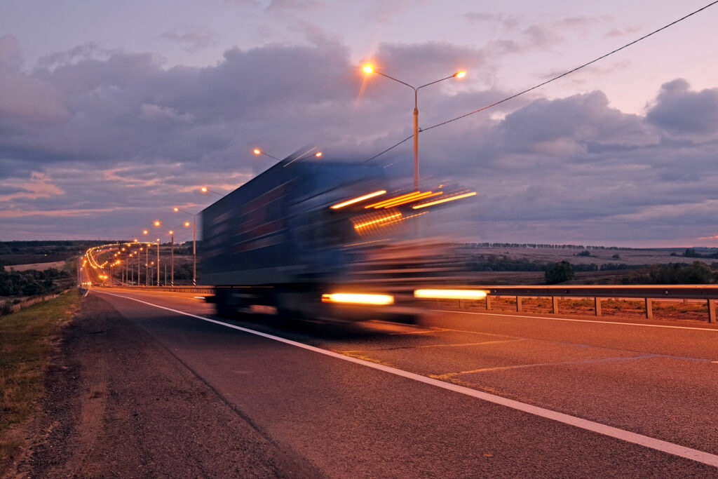 A truck traveling at high speeds on a highway.