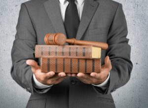 a man with law books and a gavel